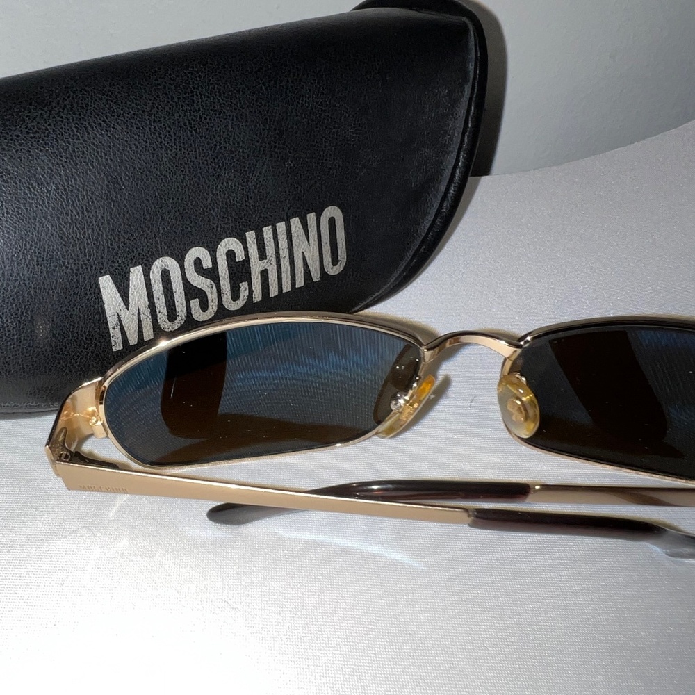 Vintage Moschino men’s sunglasses with golden metal frame.